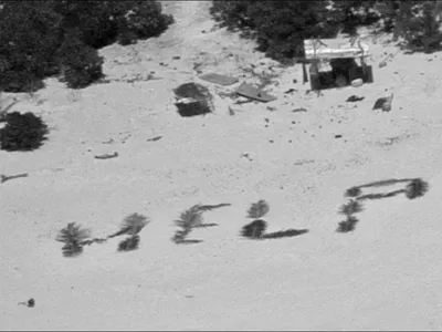 Crew aboard a U.S. Navy P-8 Poseidon aircraft spotted the men&#39;s &quot;HELP&quot; sign from the air.