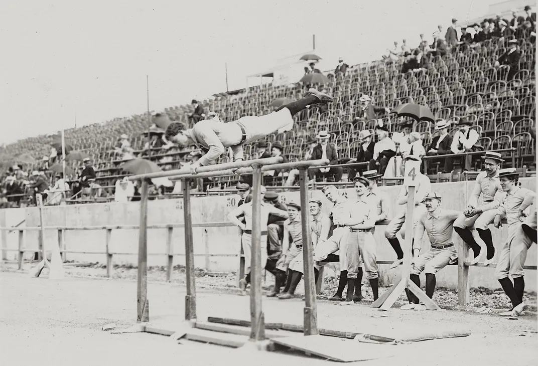 Athlete performing on the parallel bars at a Turnverein gymnastics competition in 1904