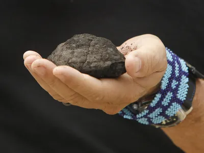 Gerard Barron, chairman and CEO of The Metals Company, holds a nodule retreived from the seafloor in the Clarion Clipperton Zone of the Pacific Ocean in 2021. The company plans to mine for these nodules, which researchers suggest produce oxygen underwater.