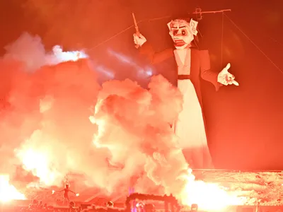 A fire dancer lights a fire beneath Zozobra during the 99th Annual Burning of Zozobra at Fort Marcy Park on September 1, 2023 in Santa Fe, New Mexico.&nbsp;