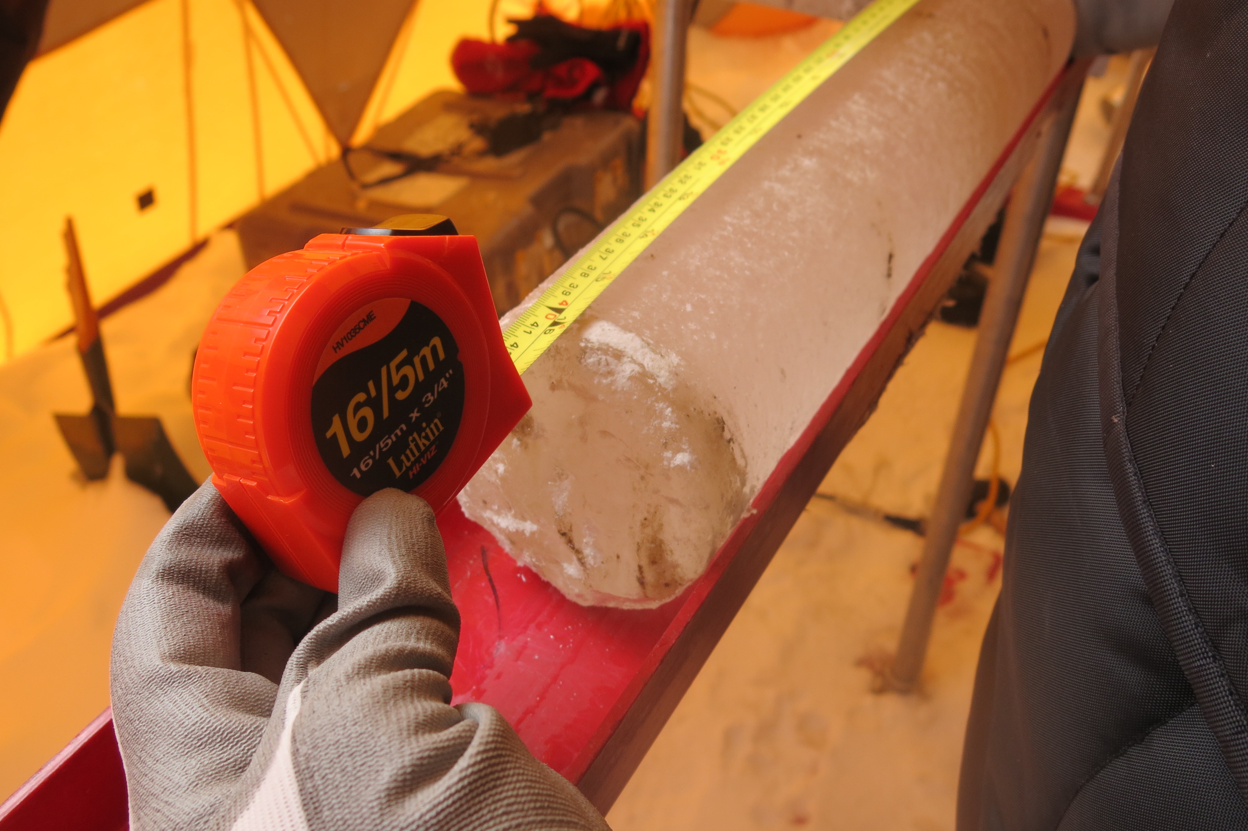 Ice core with a measuring tape.